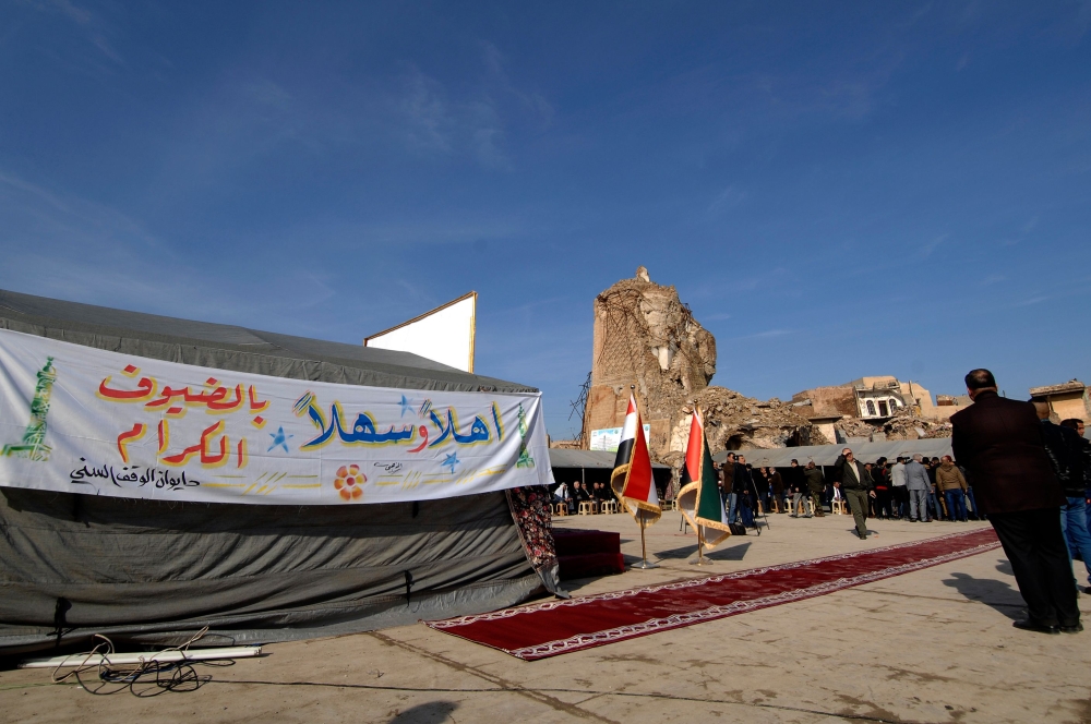 A picture taken on December 16, 2018, shows people attending the placing of the cornerstone ceremony for the rebuilding of the Great Mosque of Al-Nuri and 