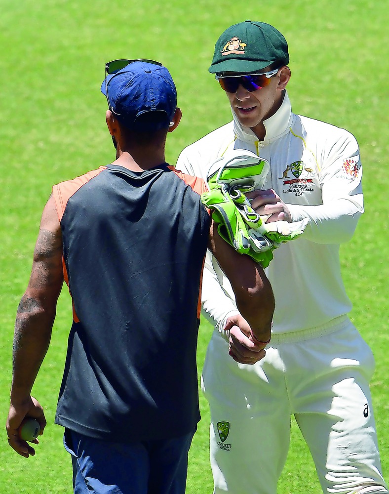 Australia's captain Tim Paine (R) shakes hand with Indian captain Virat Kohli after winning the second Test cricket match between Australia and India in Perth on December 18, 2018.  AFP / William West