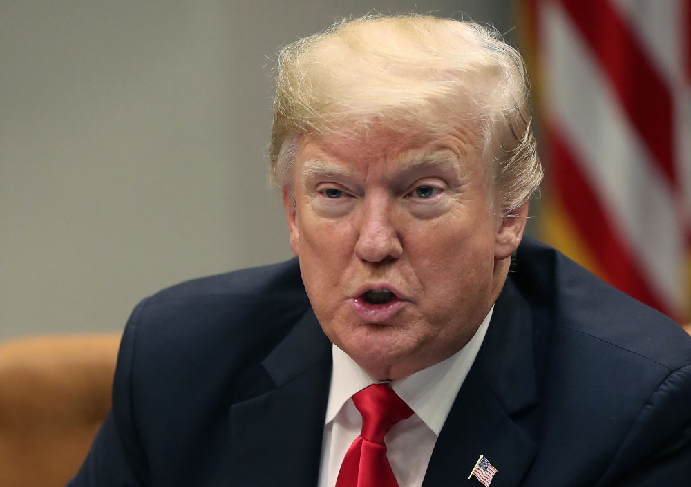 U.S. President Donald Trump leads a roundtable discussion on school safety and the new Federal Commission on School Safety report, with family members of shooting victims, state and local officials, in the Roosevelt Room on December 18, 2018 in Washington
