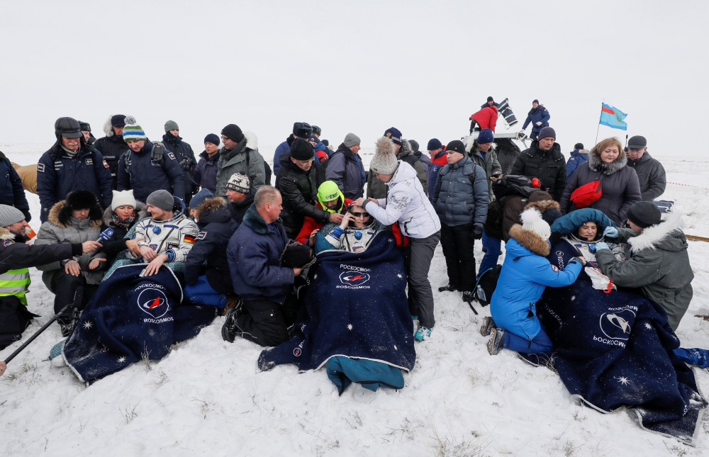 The International Space Station (ISS) crew members Serena Aunon-Chancellor of the U.S., Alexander Gerst of Germany and Sergey Prokopyev of Russia rest after the landing of the Soyuz MS-09 capsule in a remote area near the town of Zhezkazgan, formerly know