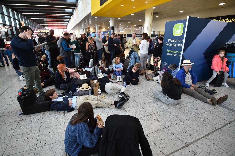 Passengers wait at the North Terminal at London Gatwick Airport, south of London, on December 20, 2018 after all flights were grounded due to drones flying over the airfield. / AFP / Glyn KIRK 