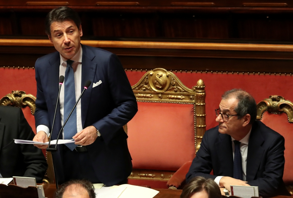 Italian Prime Minister Giuseppe Conte speaks about the government's 2019 budget, next to Italian Economy Minister Giovanni Tria, during a debate at the Senate in Rome, Italy, December 19, 2018. REUTERS/Tony Gentile