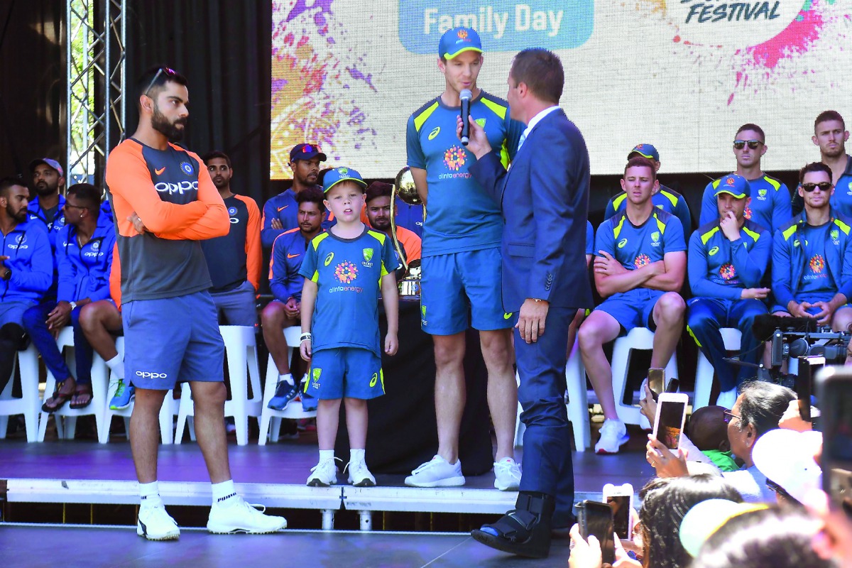 India’s captain Virat Kohli (left) and his Australian counterpart Tim Paine are interviewed during a meet the fans event in Melbourne yesterday. Archie Schiller is also seen standing next to Kohli and Paine.