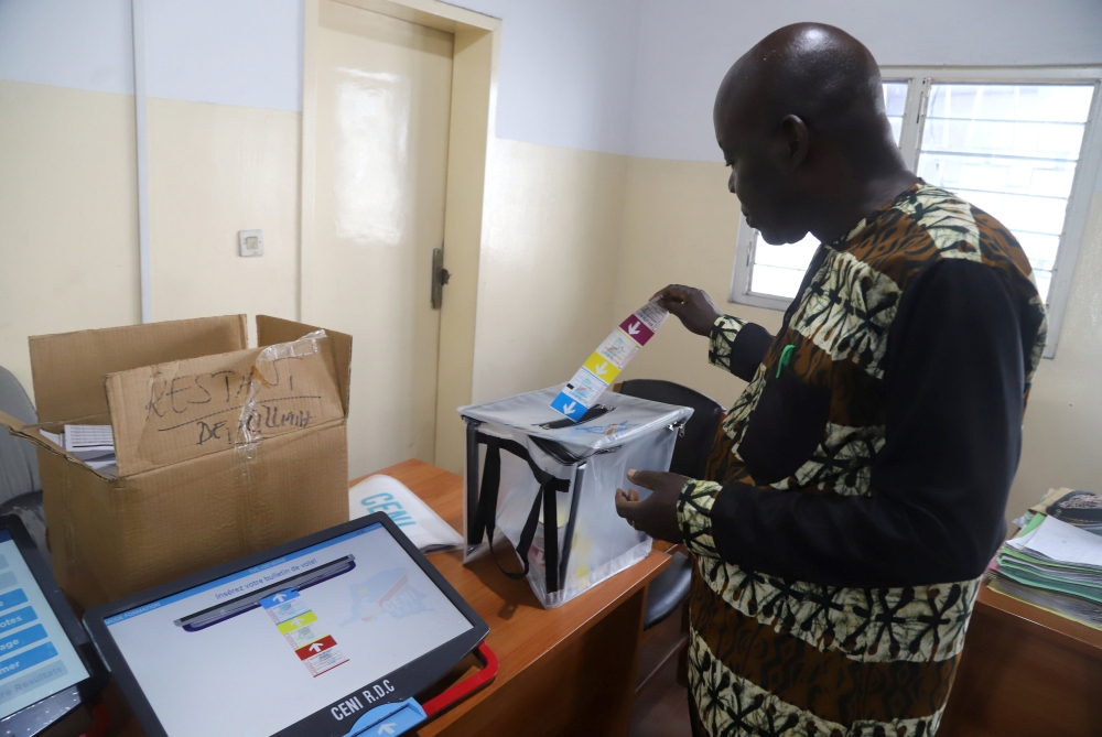 A worker of Congo's National Independent Electoral Commission (CENI), tests a voting machine ahead of the postponed presidential election, at the CENI offices in Kinshasa, Democratic Republic of Congo December 24, 2018. REUTERS/Kenny Katombe