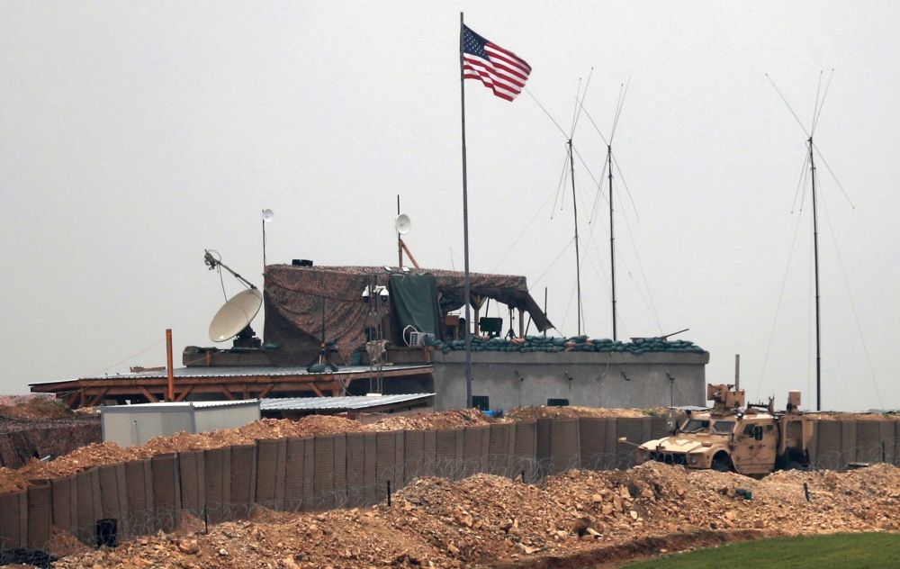 US forces' vehicles and structures are seen on the outskirts of the northern Syrian town of Manbij on December 26, 2018.   AFP / Delil souleiman