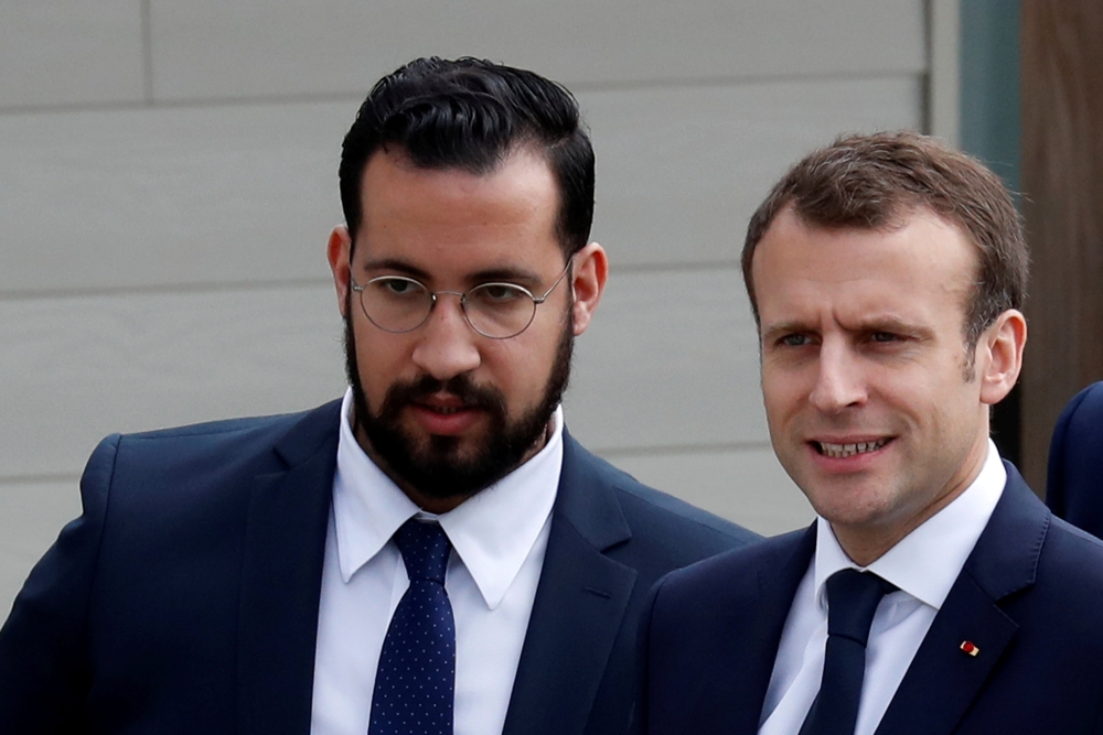 FILE PHOTO: French President Emmanuel Macron and his then senior security officer Alexandre Benalla arrive at an elementary school to attend a one-hour interview with French news channel TF1, in Berd'huis, France, April 12, 2018. Picture taken April 12, 2