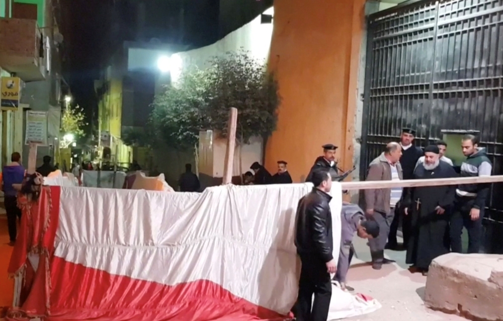 Armed police stand as a priest exits a Coptic church in this screengrab taken from video in eastern Cairo, Egypt January 5, 2019. \ REUTERS