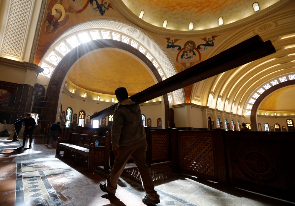 Workers clean the interior of the new Coptic Cathedral 