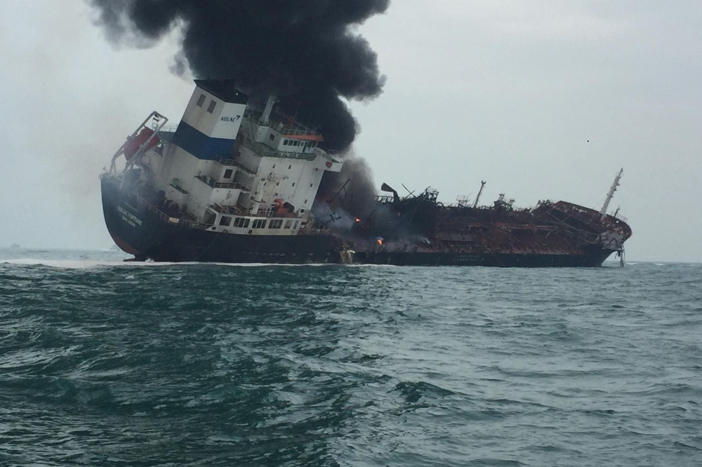 Smoke rising from an oil tanker as it tilts to one side in the waters near Hong Kong.  AFP / Hong Kong Police