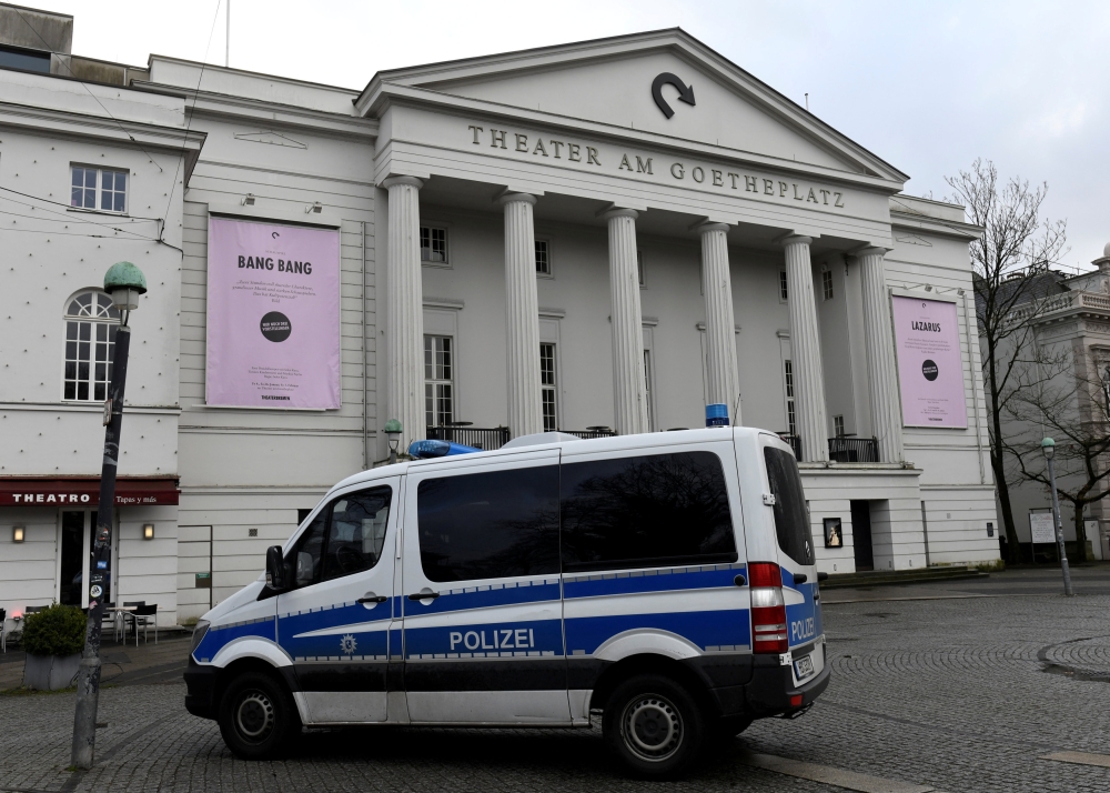 A police car stands in front of the theatre while police forces examine the crime scene at the back-side, where far-right Alternative for Germany (AfD) party member Frank Magnitz was attacked by unknown assailants, in Bremen, Germany January 8, 2019. REUT