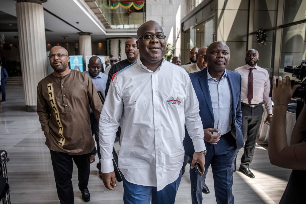 (FILES) In this file photo taken on December 29, 2018 presidential candidate Felix Tshisekedi (C) arrives for a meeting between CENI, SADC and other presidential candidates in Kinshasa, one day ahead of the general elections. AFP / Luis TATO