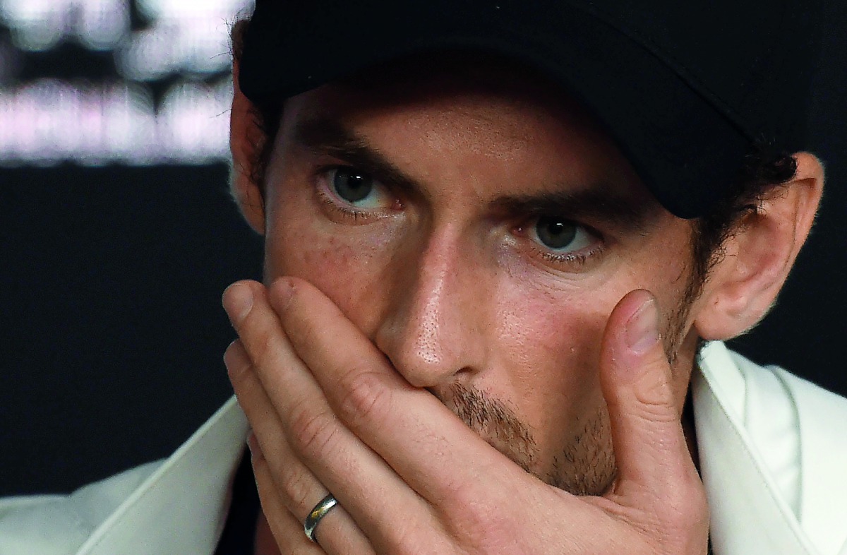 Britain's Andy Murray addresses media representatives at a press conference after defeat in his first round men's singles match against Spain's Roberto Bautista Agut on day one of the Australian Open tennis tournament in Melbourne early January 15, 2019. 