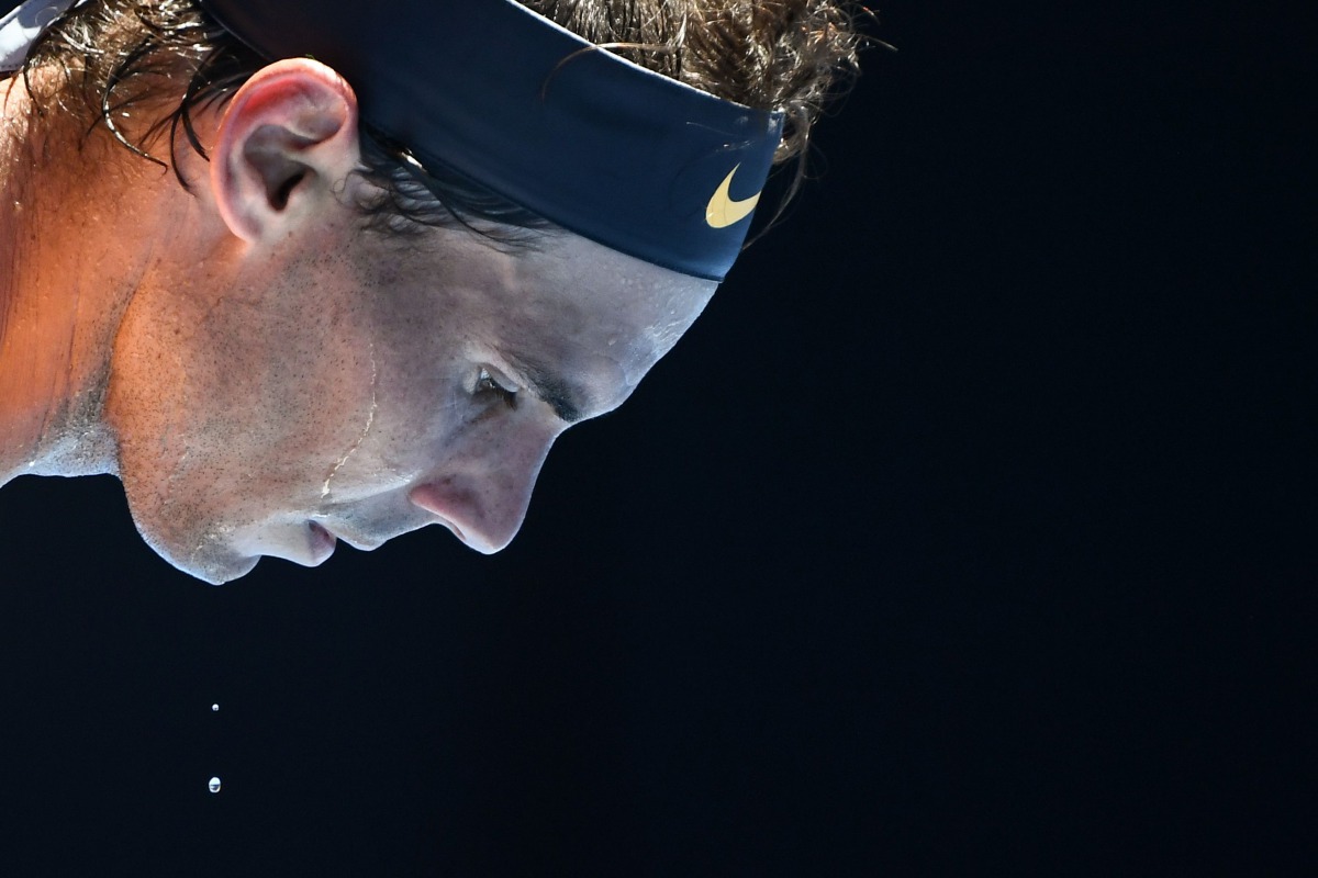 Spain's Rafael Nadal sweats as he serves against Australia's James Duckworth during their men's singles match on day one of the Australian Open tennis tournament in Melbourne on January 14, 2019. AFP / Jewel Samad