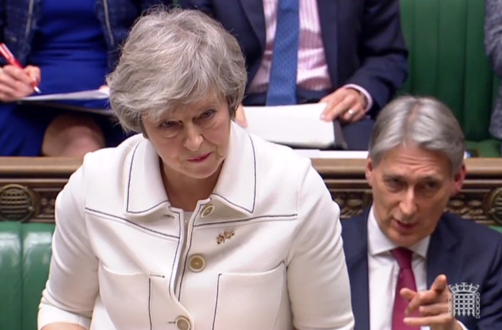 A video grab from footage broadcast by the UK Parliament's Parliamentary Recording Unit (PRU) shows Britain's Chancellor of the Exchequer Philip Hammond (R) gesturing as Britain's Prime Minister Theresa May makes a statement to the House of Commons in Lon