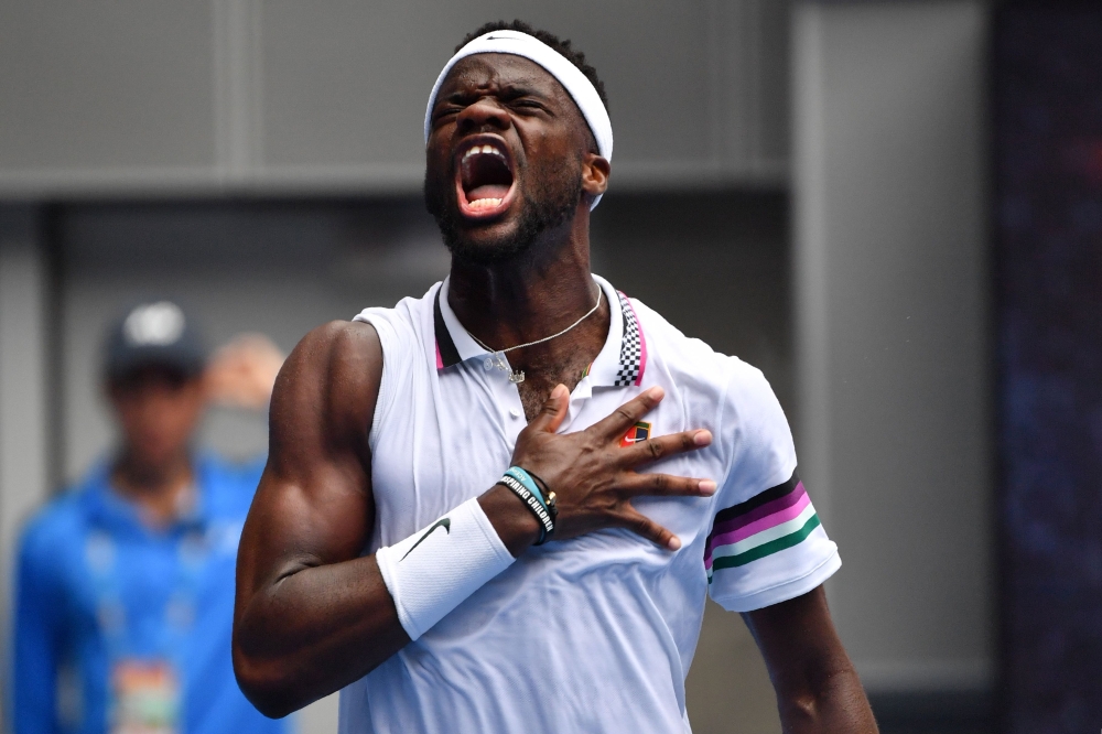 Frances Tiafoe of the US celebrates his victory against South Africa's Kevin Anderson during their men's singles match on day three of the Australian Open tennis tournament in Melbourne on January 16, 2019. 