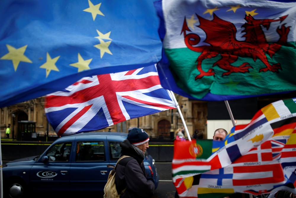 Flags flutter outside the Houses of Parliament after Prime Minister Theresa May's Brexit deal was rejected, in London, Britain, January 16, 2019. REUTERS/Henry Nicholls	