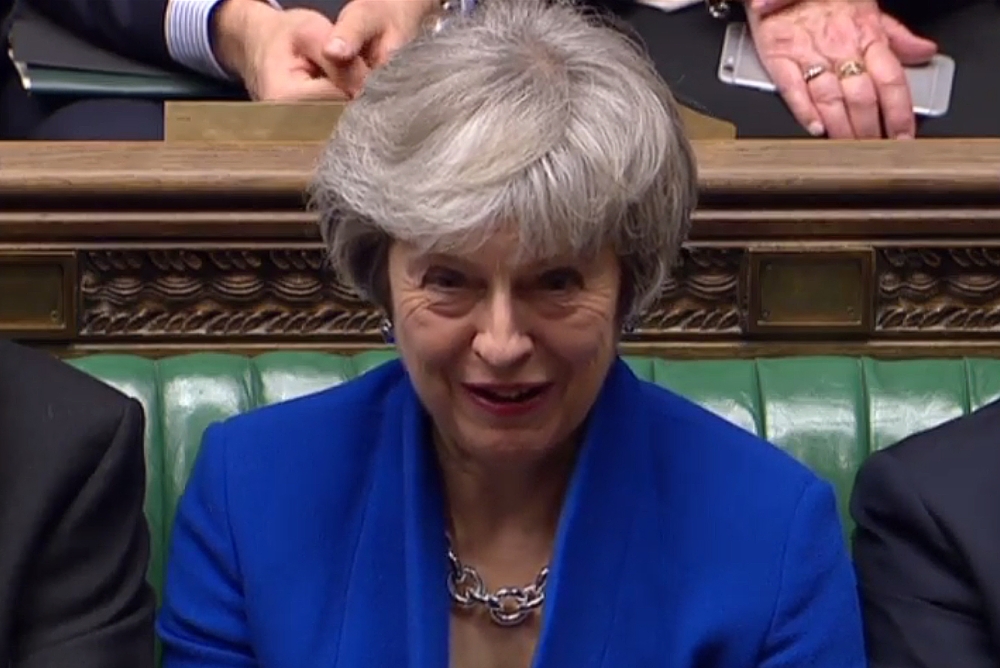 A video grab from footage broadcast by the UK Parliament's Parliamentary Recording Unit (PRU) shows Britain's Prime Minister Theresa May listen as opposition Labour's deputy leader Tom Watson speaks during a debate on a motion of no confidence, in the Hou