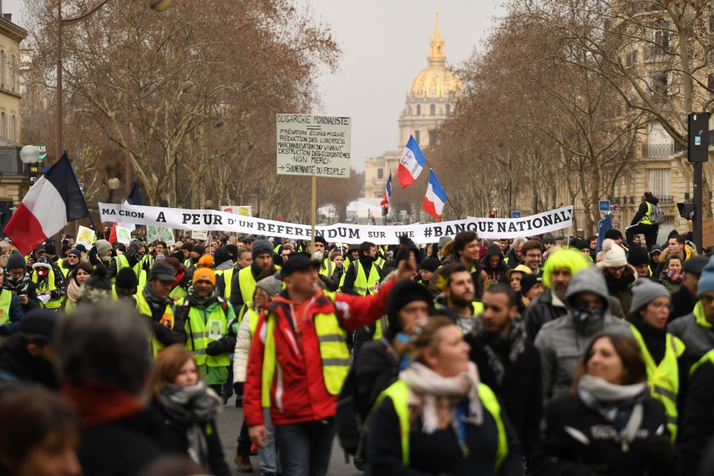 Protesters hold a banner reading 