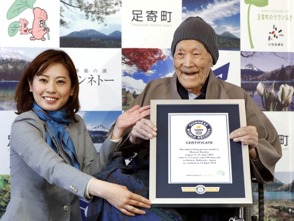 FILE PHOTO: Japanese Masazo Nonaka, who was born 112 years and 259 days ago, receives a Guinness World Records certificate naming him the world's oldest man during a ceremony in Ashoro, on Japan's northern island of Hokkaido, in this photo taken by Kyodo 