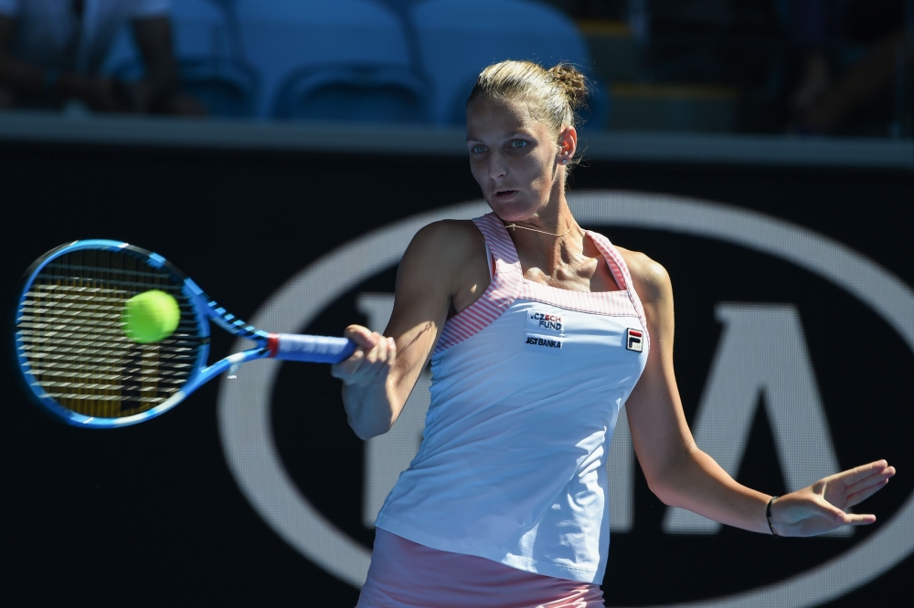 Czech Republic's Karolina Pliskova hits a return against Spain's Garbine Muguruza during their women's singles match on day eight of the Australian Open tennis tournament in Melbourne on January 21, 2019. AFP / Greg Wood 