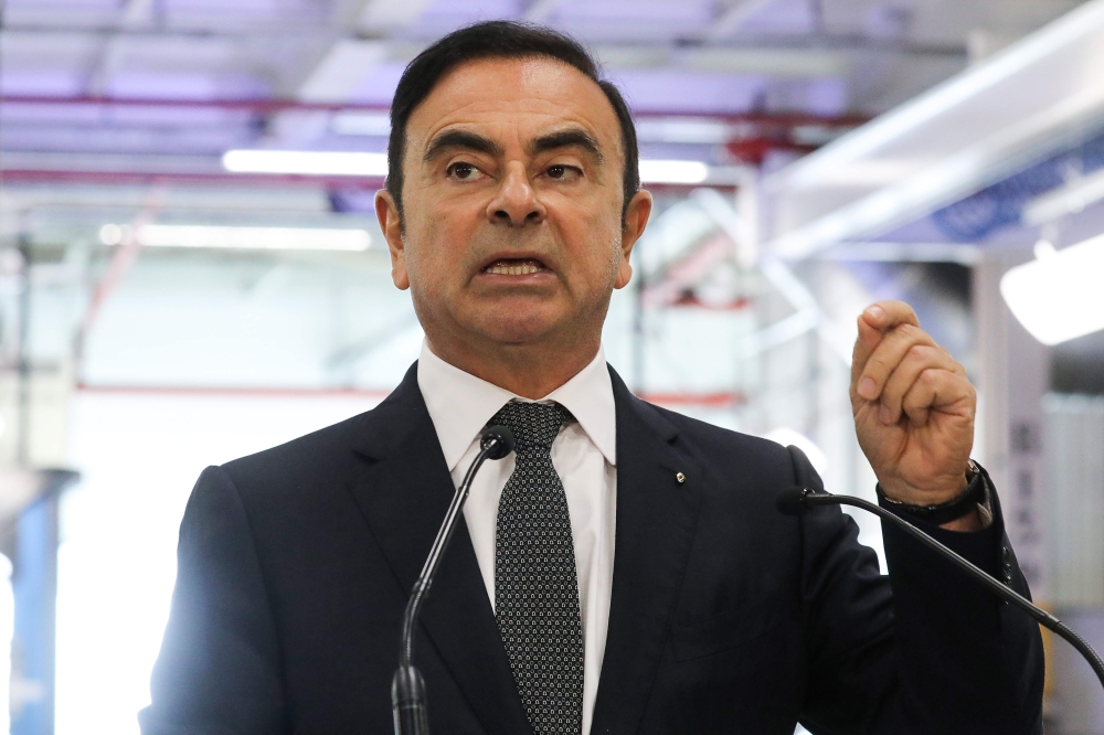 (FILES) In this file photo taken on November 8, 2018 Chairman and CEO of Renault-Nissan-Mitsubishi Carlos Ghosn gestures as he delivers a speech during a visit of French President at the Renault factory, in Maubeuge, northern France. AFP / Ludovic MARIN