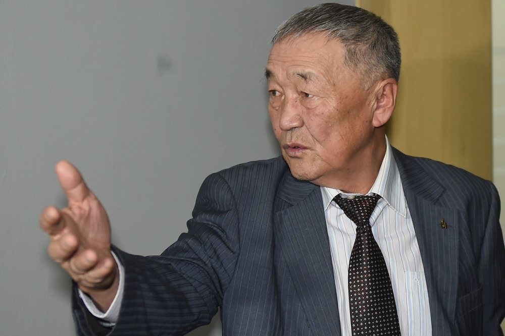 Setev Shaariibuu, the father of murdered young Mongolian woman Altantuya Shaariibuu, who is expected to testify in a civil lawsuit into her daughter's murder arrives in court in Sha Alam on January 22, 2019. / AFP / MOHD RASFAN 