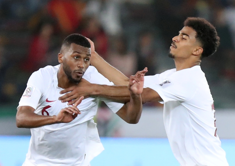 Qatar's Abdelaziz Hatim celebrates scoring their first goal with team mates. Reuters/Suhaib Salem 

