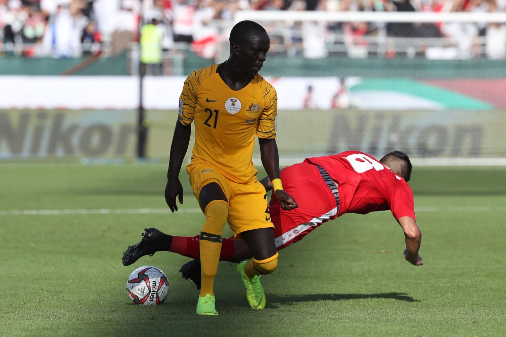 (FILES) In this file photo taken on January 11, 2019 Australia's forward Awer Mabil (L) fights for the ball with Palestine's midfielder Jonathan Zorrilla during the 2019 AFC Asian Cup group B football match between Palestine and Australia at the Maktoum B