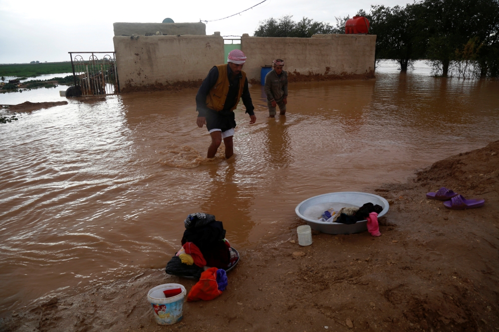 An Iraqi man walks near his home after heavy rainfall on the outskirt of Najaf, Iraq January 28, 2019. REUTERS/Alaa Al-Marjani