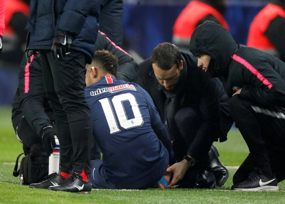 Paris St Germain's Neymar receives medical attention REUTERS/Charles Platiau