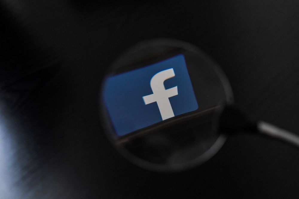 In this file photo taken on January 15, 2019 The logo of social network Facebook is displayed on a smartphone, in Nantes, western France.  / AFP / LOIC VENANCE 