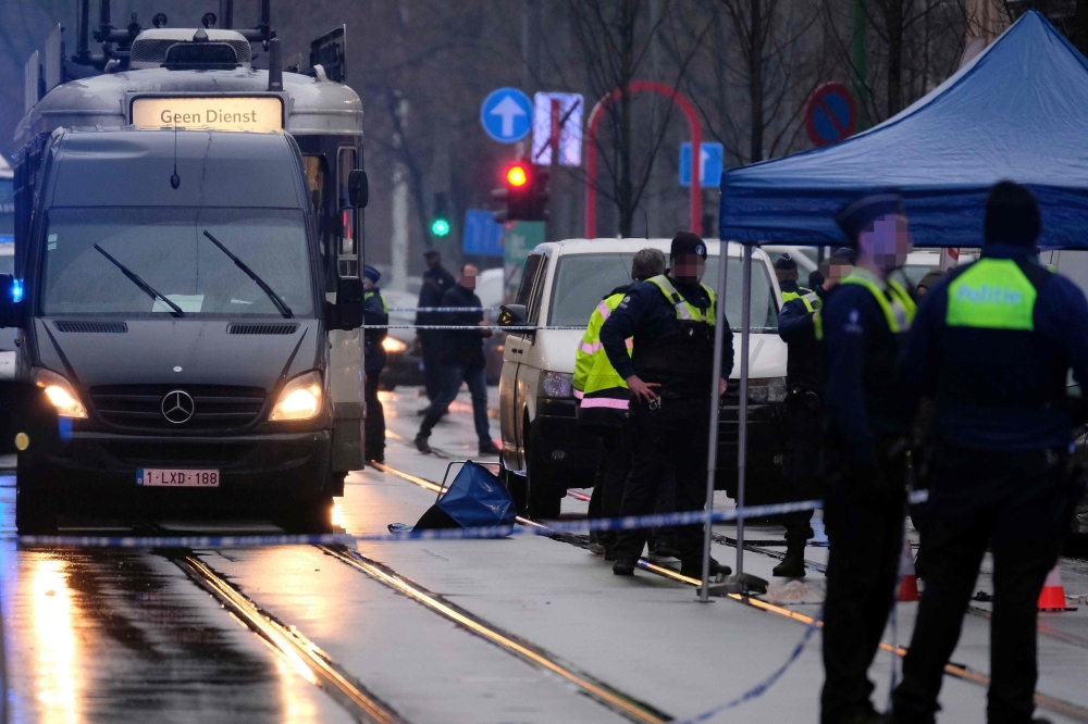 Police and forensic personnel gather at the site of a shooting at The Brederodestraat in Antwerp on February 2, 2019, as they investigate after a shooting at a Turkish cafe. AFP / Belga / NICOLAS MAETERLINCK
