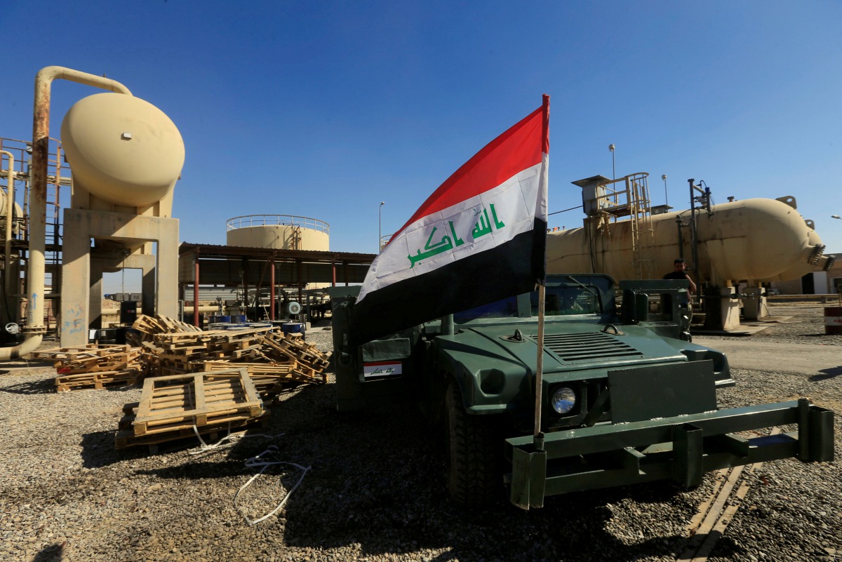 FILE PHOTO:  An Iraqi flag is seen on a military vehicle at an oil field in Dibis area on the outskirts of Kirkuk, Iraq, October 17, 2017. Reuters/Alaa Al-Marjani
