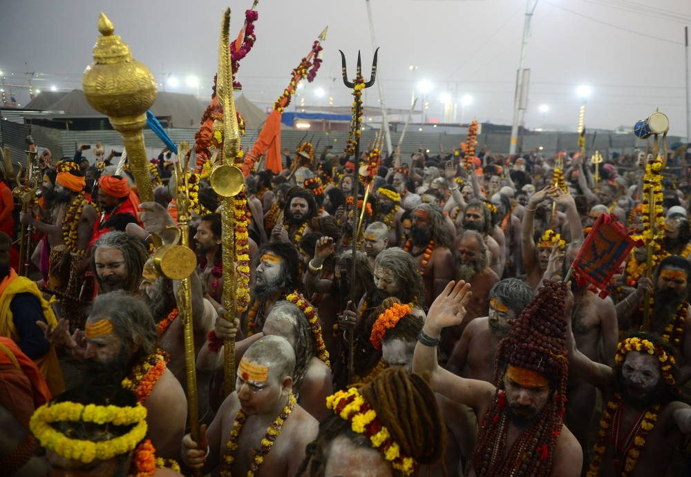Indian naked sadhu (Hindu holy man) walk in a procession towards Sangam -- the confluence of the Ganges, Yamuna and mythical Saraswati rivers -- during the auspicious bathing day of 'Mauni Amavasya' at the Kumbh Mela in Allahabad on February 4, 2019. / AF