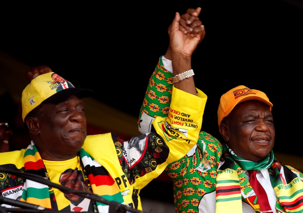 File photo of President Emmerson Mnangagwa and his deputy Constantino Chiwenga greet supporters of his ZANU PF party at a rally in Murombedzi, Zimbabwe November 24, 2018. REUTERS/Philimon Bulawayo/File Photo