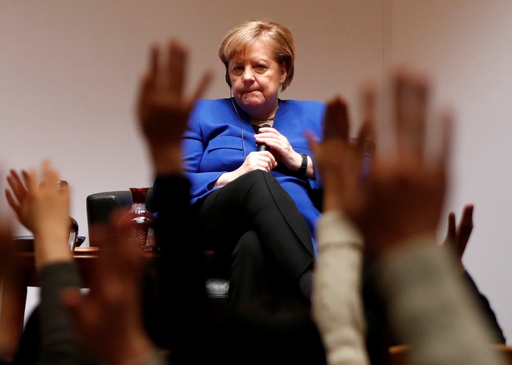 Students raise their hands to ask a question to German Chancellor Angela Merkel during her talk with students at Keio University in Tokyo, Japan, February 5, 2019. REUTERS/Issei Kato