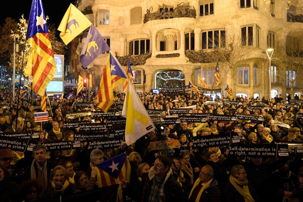 People hold placards reading 