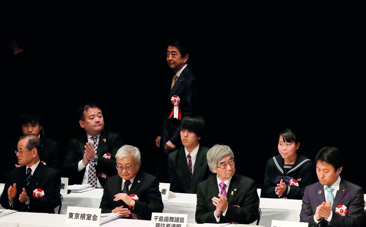 Japanese Prime Minister Shinzo Abe leaves from an annual Northern Territories Day rally that demands the return of a group of disputed islands controlled by Russia in Tokyo, Japan, February 7, 2019. Reuters/Kim Kyung-hoon