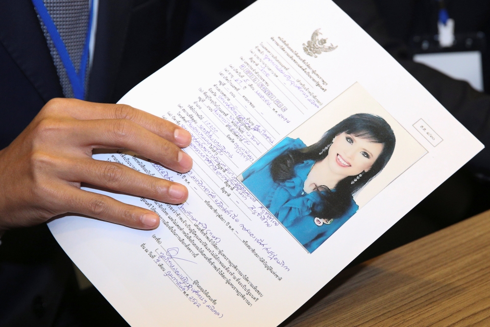 Thai Raksa Chart party leader Preechapol Pongpanich, holds up application of candidate for Prime Minister, Thailand's Princess Ubolratana Rajakanya Sirivadhana Barnavadi, at the election commission office in Bangkok, Thailand February 8, 2019. REUTERS/Ath