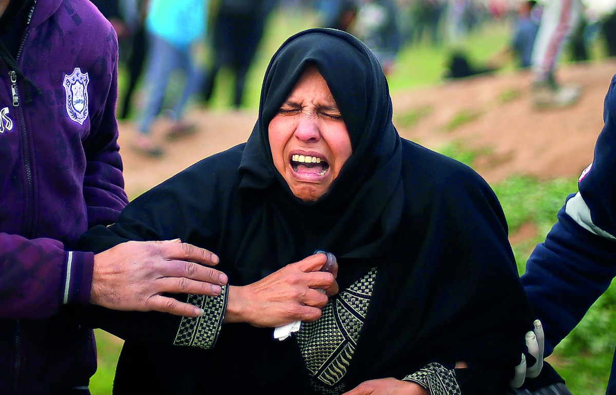 A Palestinian woman reacts from tear gas fired by Israeli troops during a protest at the Israel-Gaza border fence, east of Gaza City February 15, 2019. Reuters/Mohammed Salem