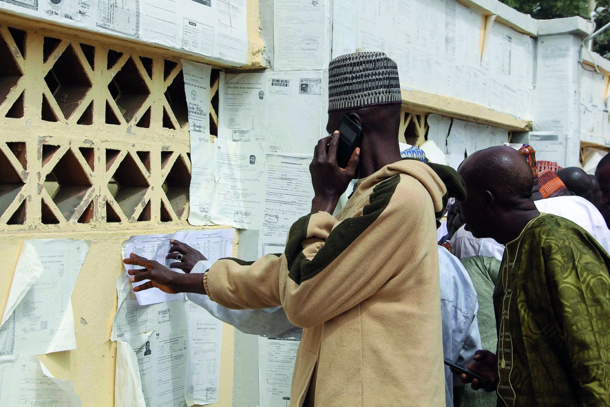 Nigerians check their names against the voters roll in Maiduguri in Borno State in north-eastern Nigeria on February 15, 2019.  AFP / Audu Marte
