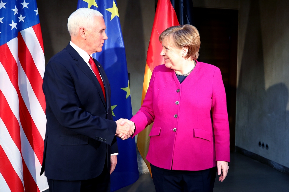U.S. Vice President Mike Pence shakes hands with German Chancellor Angela Merkel during the annual Munich Security Conference in Munich, Germany February 16, 2019. REUTERS/Michael Dalder