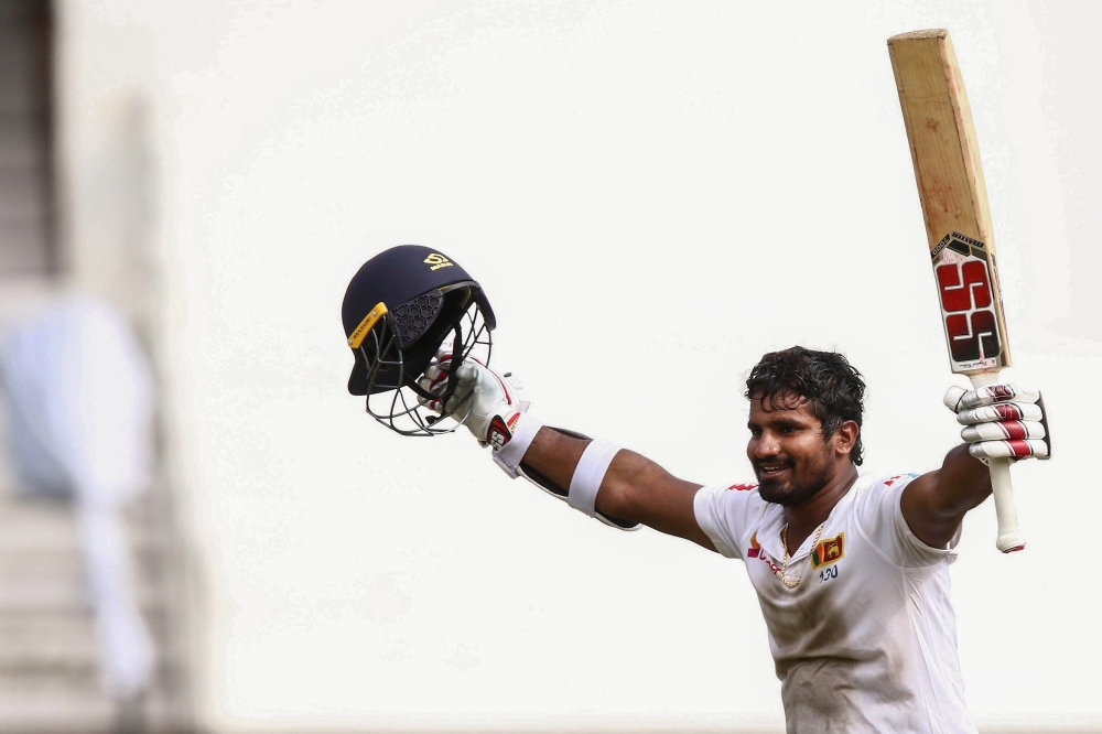 Sri Lanka's Kusal Perera celebrates the victory after hittting the winning runs of a South Africa's player during the fourth day of the first Cricket Test between South Africa and Sri Lanka at the Kingsmead Stadium in Durban on February 16, 2019. / AFP / 