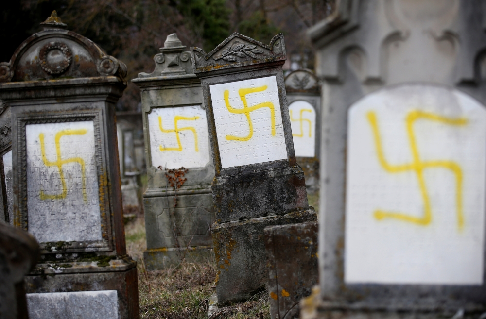 Graves that were desecrated with swastikas are seen at the Jewish cemetery in Quatzenheim, near Strasbourg, France, February 19, 2019. Reuters/Vincent Kessler