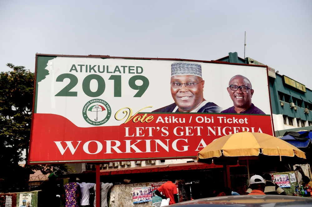 A billboard with a campaign poster bearing images of the opposition Peoples Democratic Party election candidate Atiku Abubakar and his running mate Peter Obi stands on a road in Abuja on February 19, 2019, ahead of rescheduled general elections. AFP / Piu