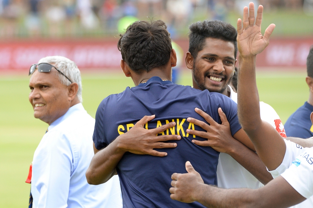 Sri Lanka's teammates celebrate after victory on the third day of the second Test cricket match between South Africa and Sri Lanka at St. George's Park Stadium in Port Elizabeth on February 23, 2019. / AFP / RODGER BOSCH