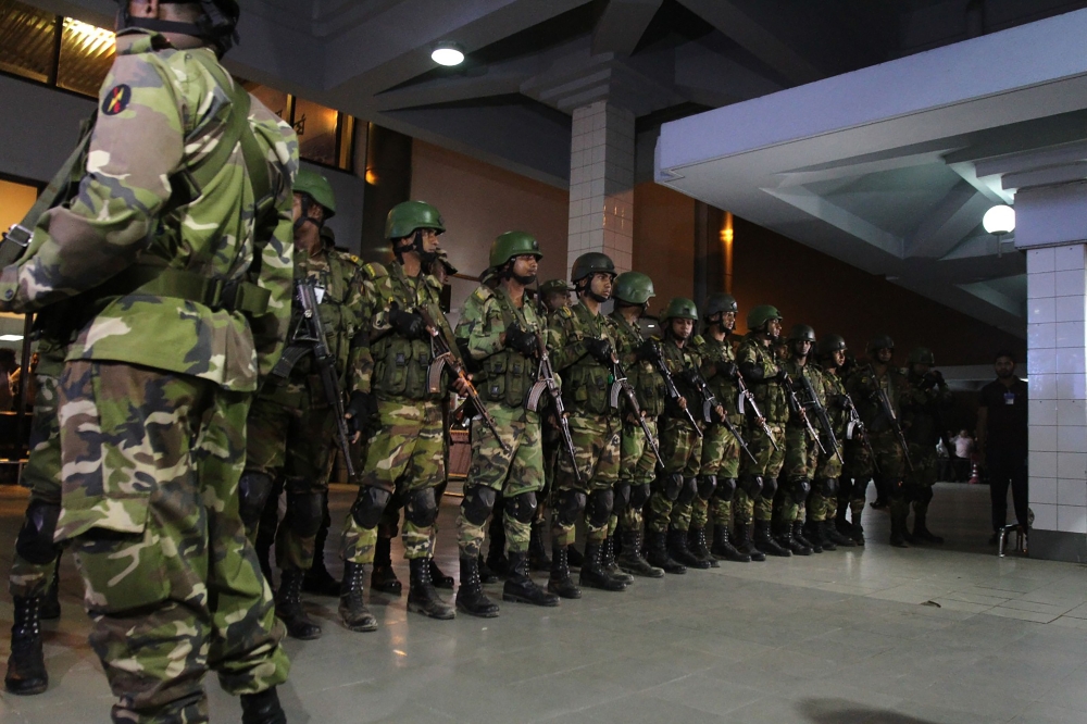 Bangladeshi security personnel stand guard at the Shah Amanat International Airport in Chittagong on February 24, 2019, after an emergency landing of the hijacked Dubai-bound Bangladesh Biman plane.  AFP 