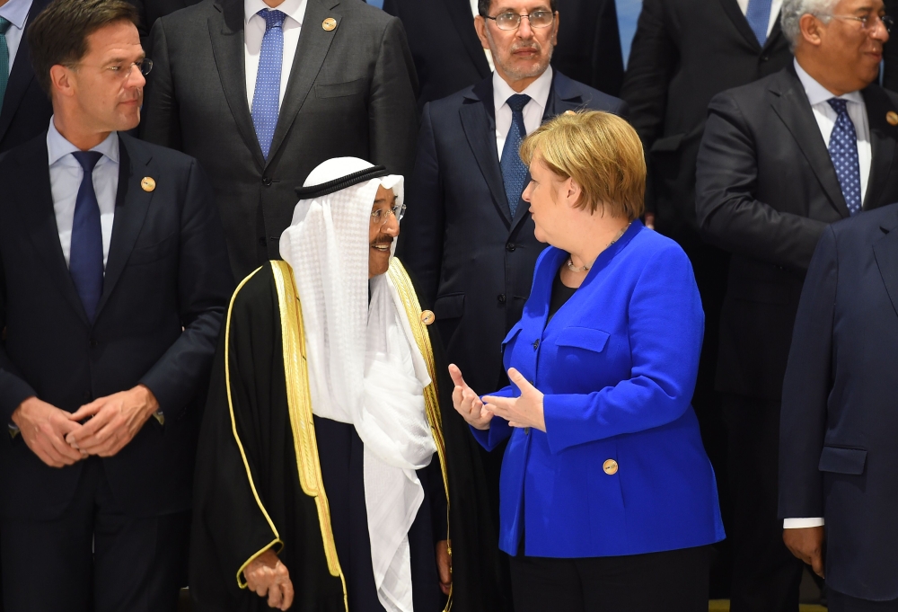 Germany's Chancellor Angela Merkel talks with Emir of Kuwait Sheikh Sabah al-Ahmad Al-Sabah during the first joint European Union and Arab League summit at the International Congress Centre in the Egyptian Red Sea resort of Sharm el-Sheikh, on February 24