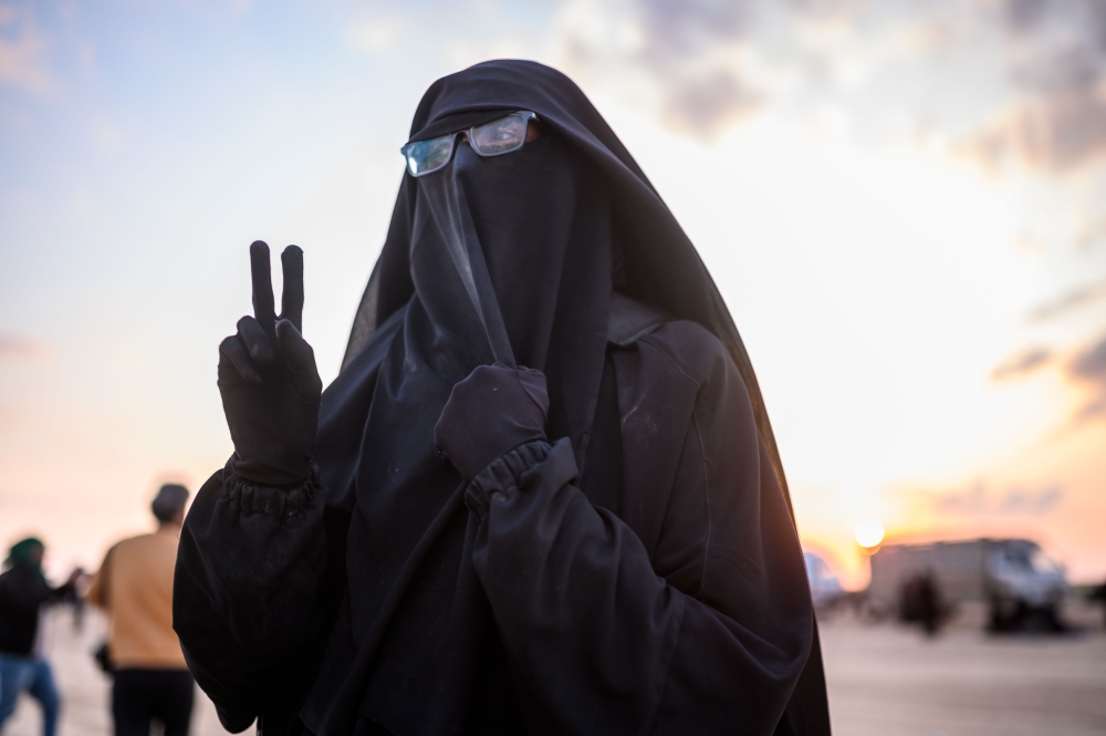 French-Tunisian Umm Yussef, 21, speaks to AFP during an interview, as she walks towards the Kurdish-led Syrian Democratic Forces (SDF) after leaving the IS group's last holdout of Baghouz, in Syria's northern Deir Ezzor province on February 22, 2019.  AFP
