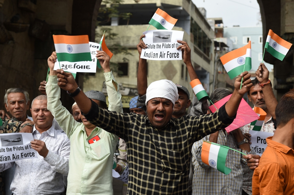 Indian Muslims shout anti-Pakistani slogans as they celebrate the Indian Air Force (IAF) strike launched on a Jaish-e-Mohammad (JeM) camp in Balakot, in Ahmedabad on February 26, 2019.  AFP / SAM PANTHAKY